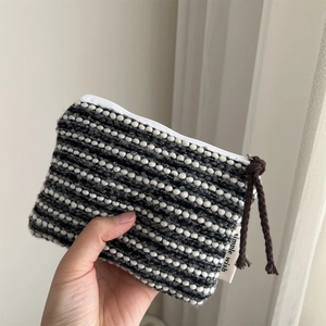 Minimalist black and white woven coin purse with high-quality zipper and cord pull