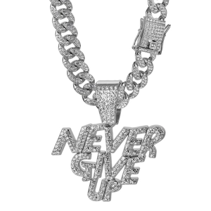 Close-up of sparkling NEVER GIVE UP pendant with rhinestones and silver Cuban chain