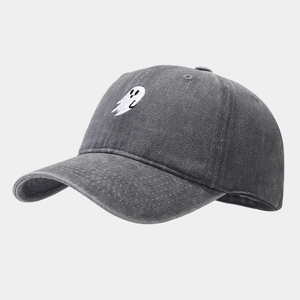 Macro detail of ghost embroidery on washed charcoal grey cotton baseball cap