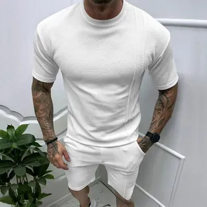 Detailed macro view of white waffle knit texture on men's summer t-shirt and shorts set