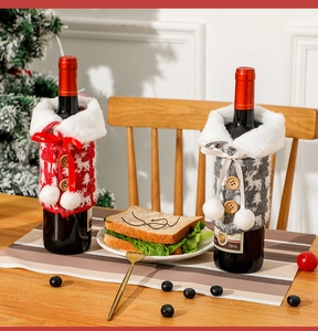 Close-up of knitted reindeer wine bottle covers with faux fur trim in festive home setting