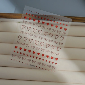 3D metallic red nail stickers featuring bowknot and heart patterns for nail art design