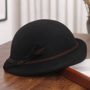 Detail of wool cloche hat with a vintage brim and brown ribbon bow decoration