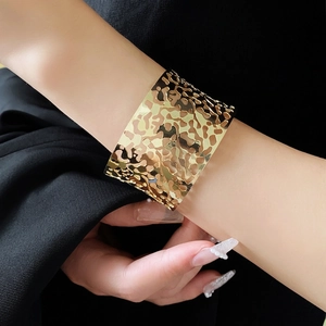 Irregular hollow open cuff bracelet in gold finish with a modern geometric design