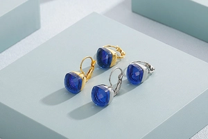 Detailed view of dark blue square cut crystals in gold and silver plated earrings
