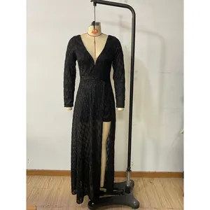 Detail of elegant black V-neck sequined evening dress with mesh sleeves and high slit