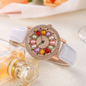 Detail of luxury women watch with rhinestone bezel and colorful gemstone flower dial