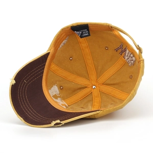 Washed mustard cotton baseball cap with letter W embroidery and distressed brim details