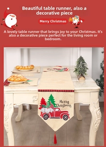 Detailed view of beige linen Christmas table runner with red truck and fringe accents