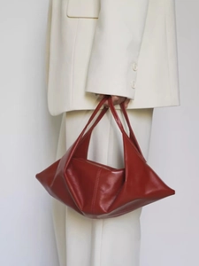 Minimalist burgundy wax leather shoulder bag shown with chic minimalist styling