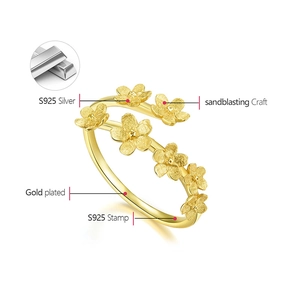 Macro shot of S925 sterling silver gold-plated ring with five floral petals details