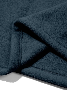 Macro shot of dark blue fleece fabric showing soft texture and premium stitching details