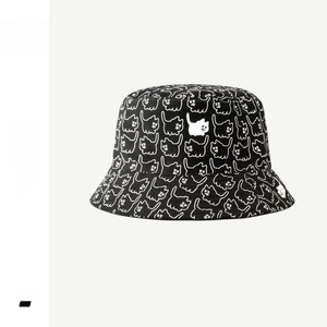Detailed macro view of black cotton bucket hat featuring all-over white cat line art prints