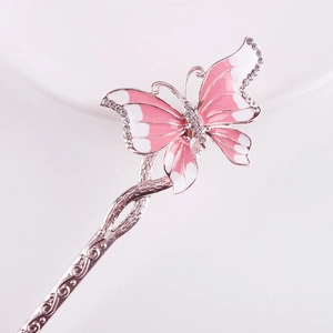 Detail of metal hairpin with pink enamel butterfly and sparkling rhinestone accents