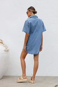 Back view of a casual loose blue denim short sleeve shirt dress on a model