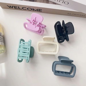 Set of matte square hair claws in pink black green white and blue on white background