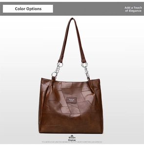 Detail of dark brown patchwork leather tote bag with silver chain straps and brand name tag