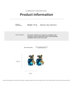 Detailed view of vintage goldfish earrings with blue rhinestones and gold alloy texture