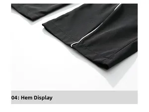 Macro detail of high-quality black straight pants cuff with side white piping and neat seams