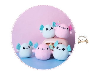 Close-up of cute pink and blue plush axolotl dolls with colorful rainbow gradients