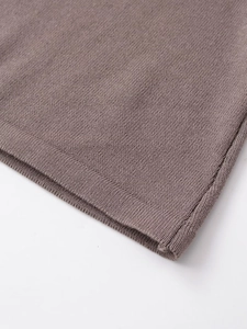 Close-up of brown knit fabric showing detailed texture and high-quality edge craftsmanship