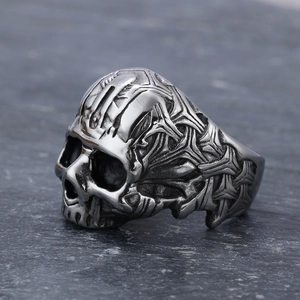 Gothic skull ring in vintage silver stainless steel on dark stone surface