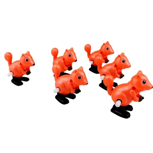 Set of six orange wind-up squirrel toys with acorns on a plain white background