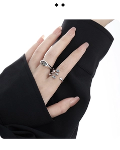 Close-up of S925 silver rings with minimalist band and branch design worn by a model