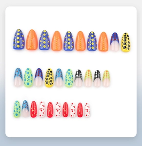 Flat lay of colorful polka dot press-on nails set including various sizes and vibrant colors