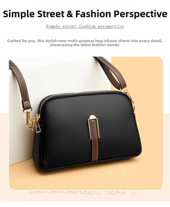 Detail of black lychee grain leather crossbody bag with brown strap and gold hardware