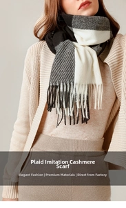 Detail of soft black and white plaid scarf with elegant fringe texture and cozy knit feel