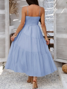 Detail of light blue maxi dress with elastic smocked back and tiered skirt design