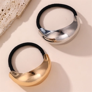 Close-up of gold and silver minimalist metal crescent elastic hair ties in a pair