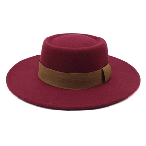Detailed top view of a flat top burgundy wool felt hat with a brown decorative band
