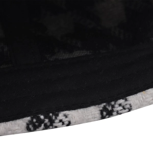 Detailed macro view of black lace mesh and tweed fabric texture on a baseball cap