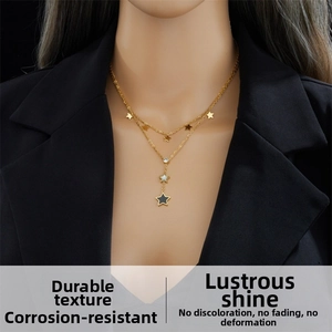 Close-up of a double-layered gold stainless steel necklace with star pendants and rhinestone