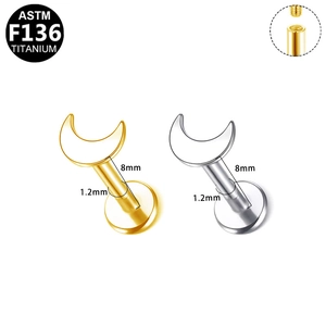 Detailed view of ASTM F136 titanium moon labret studs in gold and silver finishes