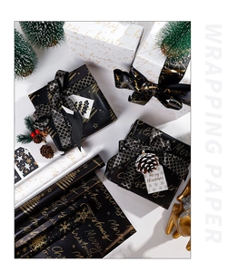 Macro shot of black and gold Christmas wrapping paper with Merry Christmas art text