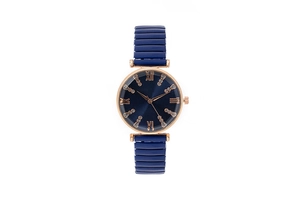 Detail of rose gold watch case with navy blue sunray dial and elastic strap