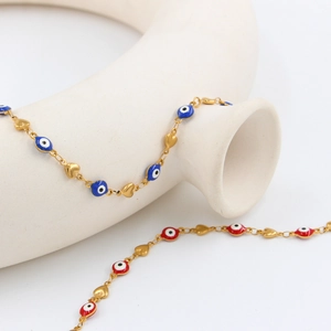 Gold evil eye charm bracelet with heart accents in blue and red enamel finish