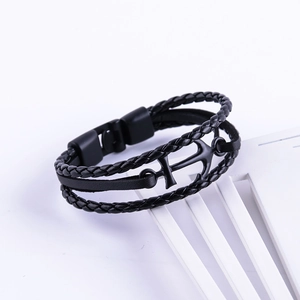 Close-up of black multilayer braided leather bracelet with vintage anchor clasp