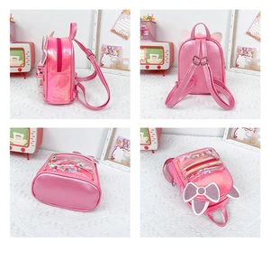 Detail view of pink cat ear backpack featuring glitter bow and sequin compartment