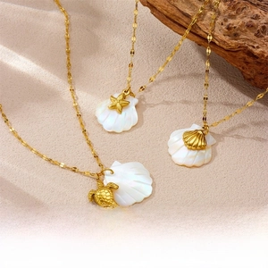 Detailed view of 18K gold ocean pendants featuring seashells, starfish and sea turtles