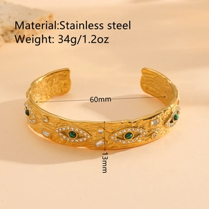 Irregular vintage gold-plated stainless steel cuff bracelet with evil eye elements