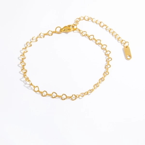 Detailed macro view of 18k gold heart-shaped link chain with lobster clasp and extender