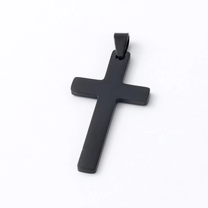 Close-up of a sleek black stainless steel cross pendant with a polished mirror finish