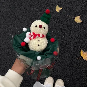 DIY Christmas snowman bouquet with white flowers, green knit hat and red striped scarf