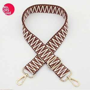 Detail of adjustable wide woven shoulder strap with brown and white wave pattern