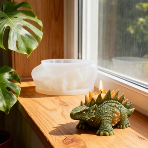 Creative ankylosaurus candle with detailed silicone mold on a sunlit wooden windowsill