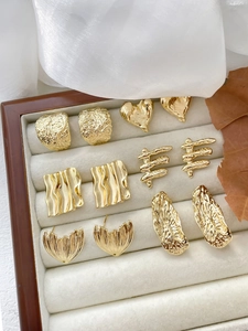 Detailed view of 14k gold plated irregular heart and square stud earring components